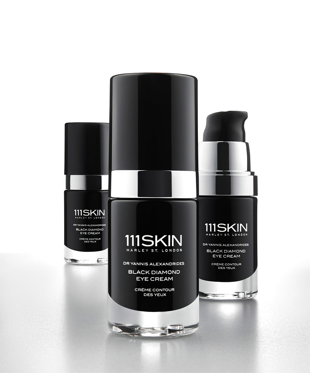 3 bottles of 111SKIN Eye Cream, one with the cap removed.