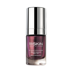 Bottle of Repair Serum NAC Y²™ with a deep purple glass body and shiny silver cap, a luxury skincare serum designed to repair and restore skin.